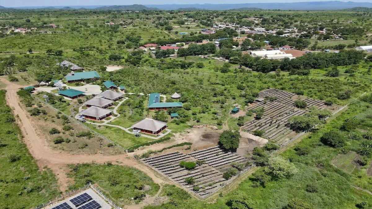 After image shows an intentionally designed site with numerous water harvesting structures, trees and plants planted, a tree seedling nursery, and various buildings.