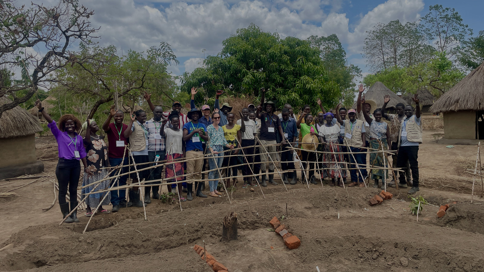Group of training participants smiling at camera. 