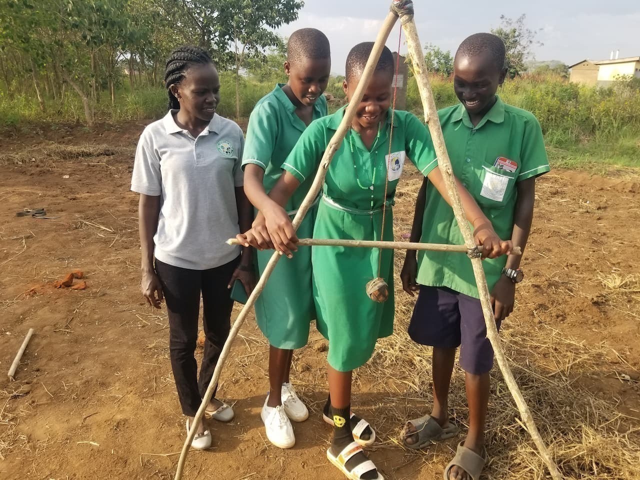 Young students use an a-frame level to mark contour of the land.